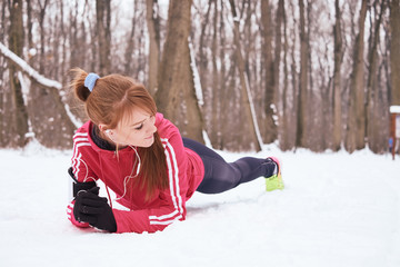 Woman jogging in the snow on the nature in winter