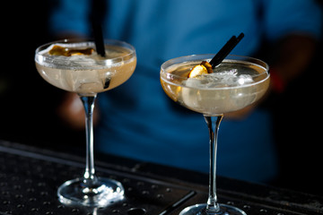 The bartender prepares a cocktail on the bar.