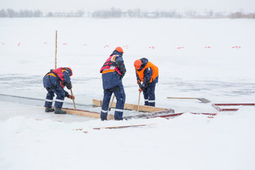 Sailors work at the lane with a fenced wooden formwork