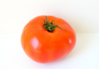 Tomato isolated in white background. Full depth of field. - Image