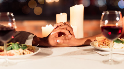 Unrecognizable Spouses Holding Hands Interlocking Fingers On Table In Restaurant