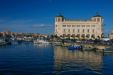 Syracuse harbor at sunset, Sicily, Italy