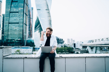 Excited entrepreneur enjoying triumph in business district