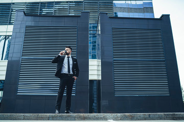 Businessman drinking hot beverage during break on street