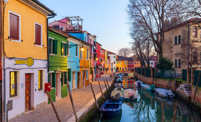Fototapeta na wymiar Lovely house facade and colorful walls in Burano, Venice. Burano island canal, colorful houses and boats, Venice landmark, Italy. Europe
