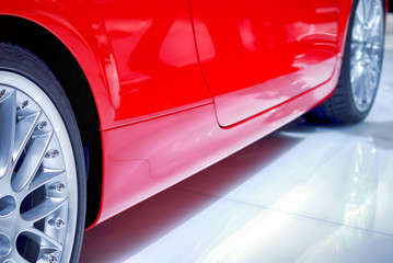 Close-up view at brand new, red sport car.