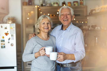 Elderly Couple drinking coffee in their home