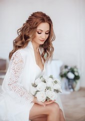 Beautiful bride with stylish make-up in white dress.Morning bride