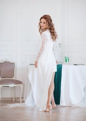 Beautiful bride with stylish make-up in white dress.Morning bride