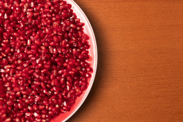 Pomegranate seeds in plate close up 