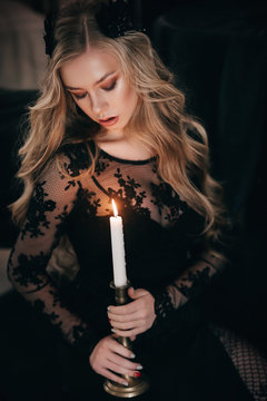 Stock Photo - beautiful young witch  girl. Halloween girl in black