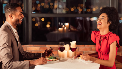 Happy Couple Having Romantic Date Talking And Laughing In Restaurant