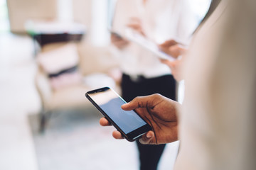 Ethnic person using smartphone at work