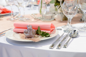 Wedding table place setting, plates and glasses