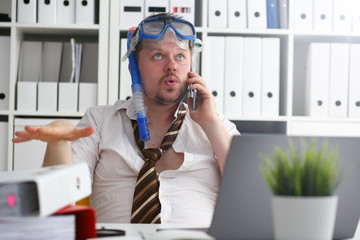 Man wearing suit and tie in goggles and snorkel talk cellphone at office workplace ready to take off portrait. Count days to leave annual day off workaholic freedom fun tourism resort idea concept