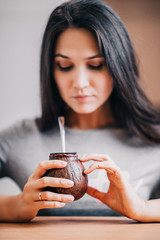 Attractive woman with calabash in her hands raises her tone and energy with a mate