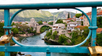 View of the panorama of Mostar through the fence of a Port Bridge over the Neretva river. Mostar, Bosnia and Herzegovina