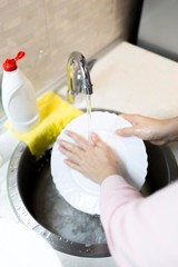 woman washing dishes in kitchen