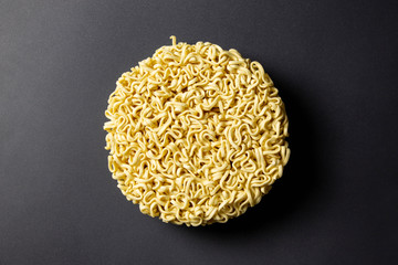 Raw instant noodles close up on black background