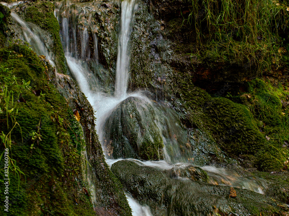 Wall mural soft waters running on rocks. close-up of running water as a picture background