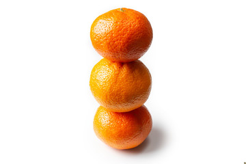 Three tangerines on a white background close-up