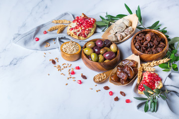 Fototapeta premium Tu Bishvat holiday symbols - dried fruits, pomegranate, barley, wheat