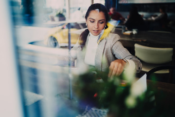 Young lady taking menu in coffee shop