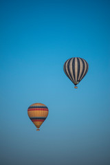 Cappadocia, Turkey, Europe: traditional hot air balloons floating after dawn in the sky over the valley of Cavusin in the historical region in Central Anatolia rich of exceptional natural wonders