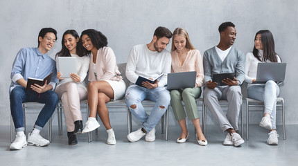 Young cheerful international people waiting for job interview