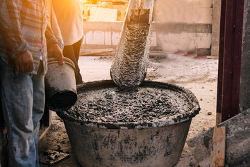 concrete mixer truck pouring concrete into large basin in construction site