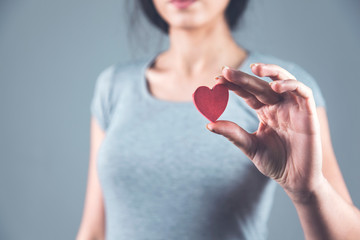 woman hand holding red heart