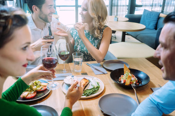 Friends in a restaurant having a jolly good time enjoying the food