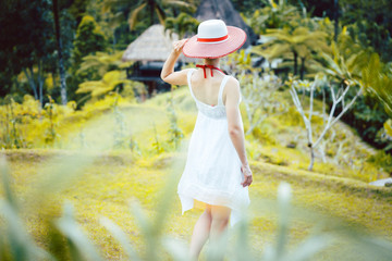 Woman in tropical vacation walking through the jungle