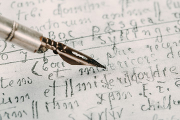 Fountain pen on an ancient handwritten letter. Old story. Retro style.