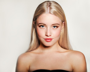 Portrait of beautiful blonde young woman face.  Spa model girl with fresh clean skin isolated on a...