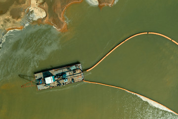 A dredger working in the quarry for sand mining. Aerial view