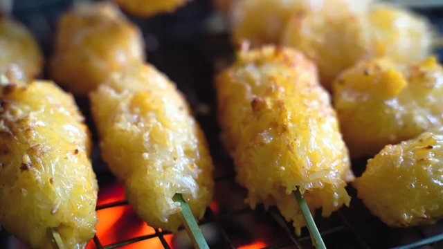 Khao jee: a street style Thai style grill sticky rice, with egg paste. a grill shot for experience on the charcoal turtle. 4K