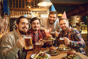 Happy friends celebrate a birthday party.