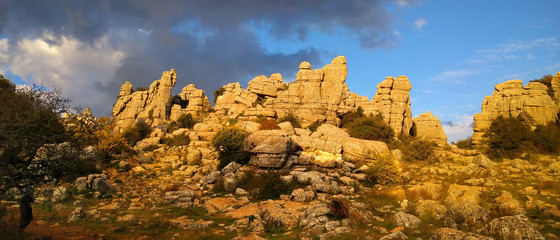 Panorama view on beautiful limestone formations in the impressive karst landscape of El Torcal de Antequera at sunset, Spain, Europe