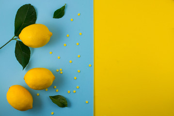 Fresh lemon pattern on a vivid blue background. Flat lay, top view, copy space. Lemon framework, spring, vitamins, body detox concept