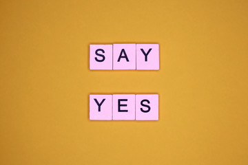 Fototapeta na wymiar Say yes, on a yellow background. Motivational poster