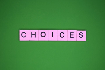Choices word wooden cubes on the green background.