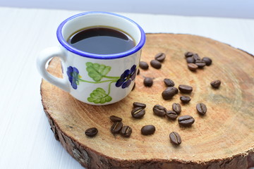  Traditional Colombian coffee cup and coffee beans on wooden background