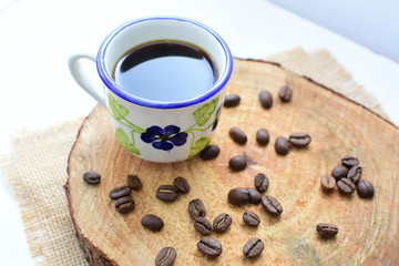  Traditional Colombian coffee cup and coffee beans on wooden background