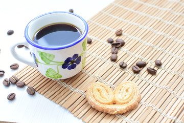  Traditional Colombian coffee cup and coffee beans on wooden background