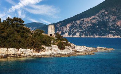 Old Venetian lighthouse in the Fiskardo port. Wonderful Sunny seascape of Ionian Sea, Kefalonia island. Greece