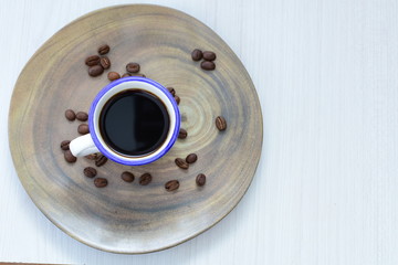  Traditional Colombian coffee cup and coffee beans on wooden background