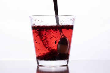 Close up of transparent glass with tea and spoon