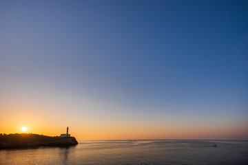 Portocolom lighthouse with sunrise, copy space