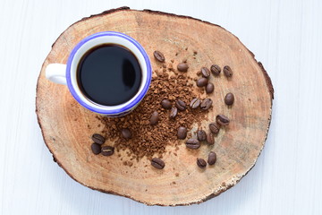  Traditional Colombian coffee cup and coffee beans on wooden background